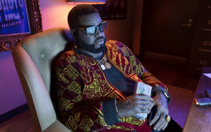 GTA 6 pre-orders: Boobie Ike holding a stack of cash in his Vice City office